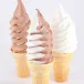 Three soft serve cones in chocolate, swirl, and vanilla flavors