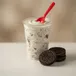 Oreo flurry blended treat with crushed Oreo cookies and a red spoon