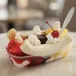 Banana split with strawberry, pineapple and chocolate toppings, whipped cream and cherries