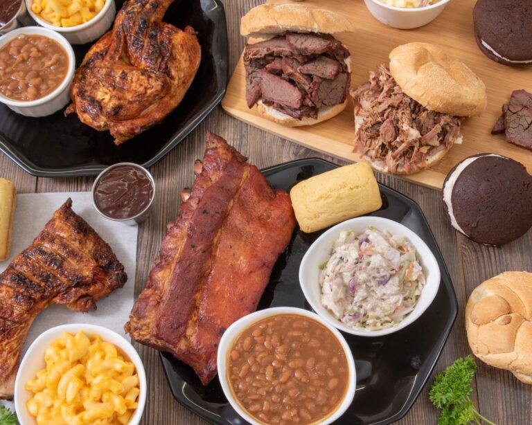 Full spread of Bell's Breakaway BBQ menu: smoked chicken, ribs, pulled pork and brisket sandwiches, and sides